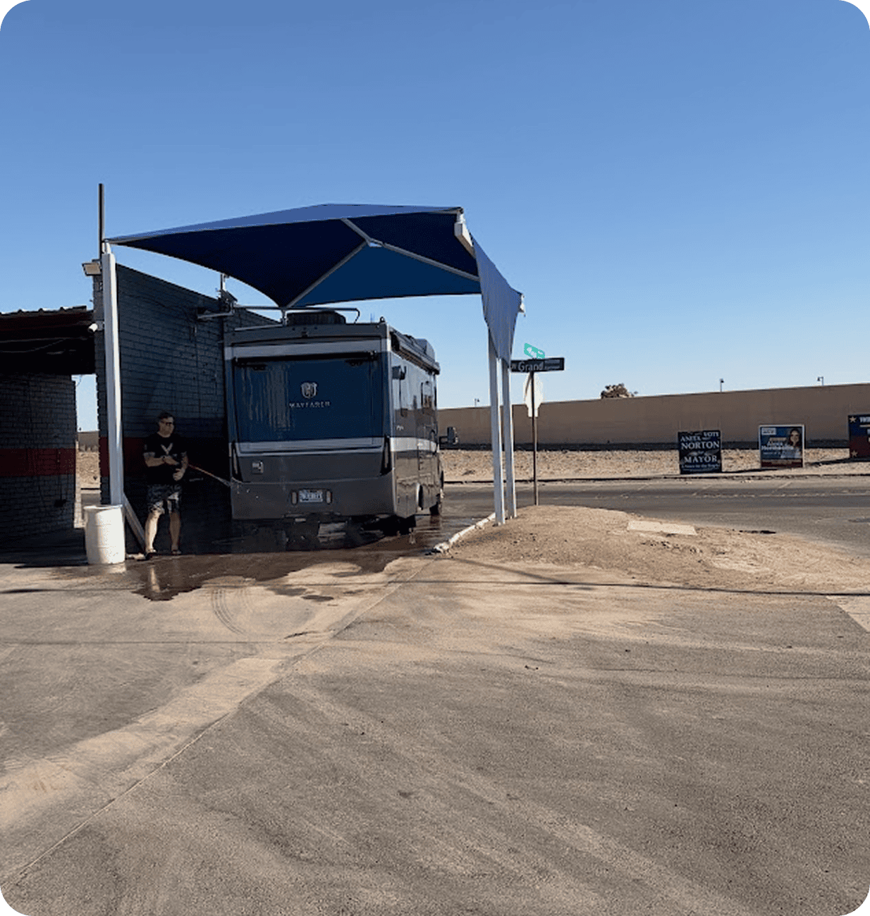 Man washing an RV at outdoor station