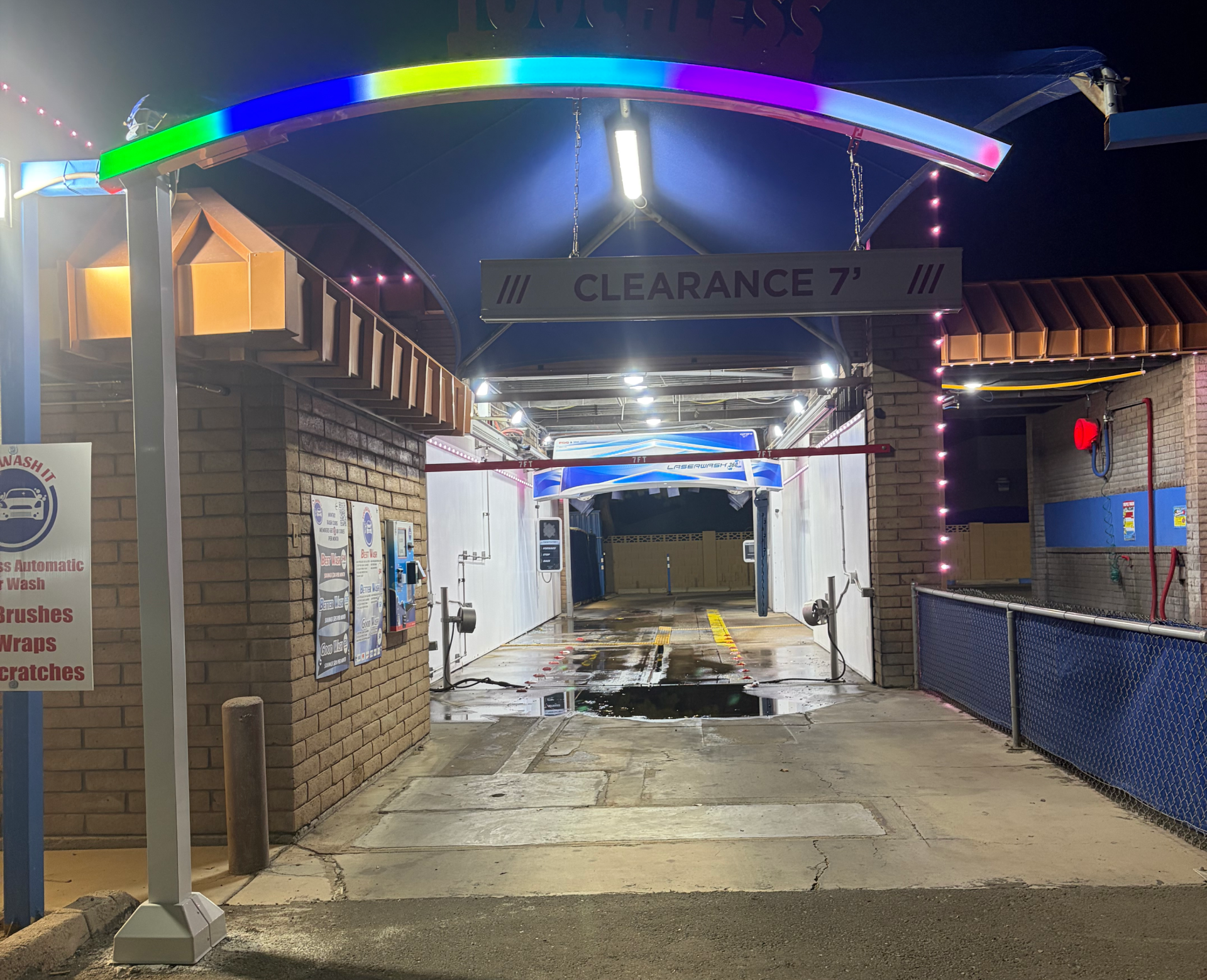 Car wash entrance at night with lights.