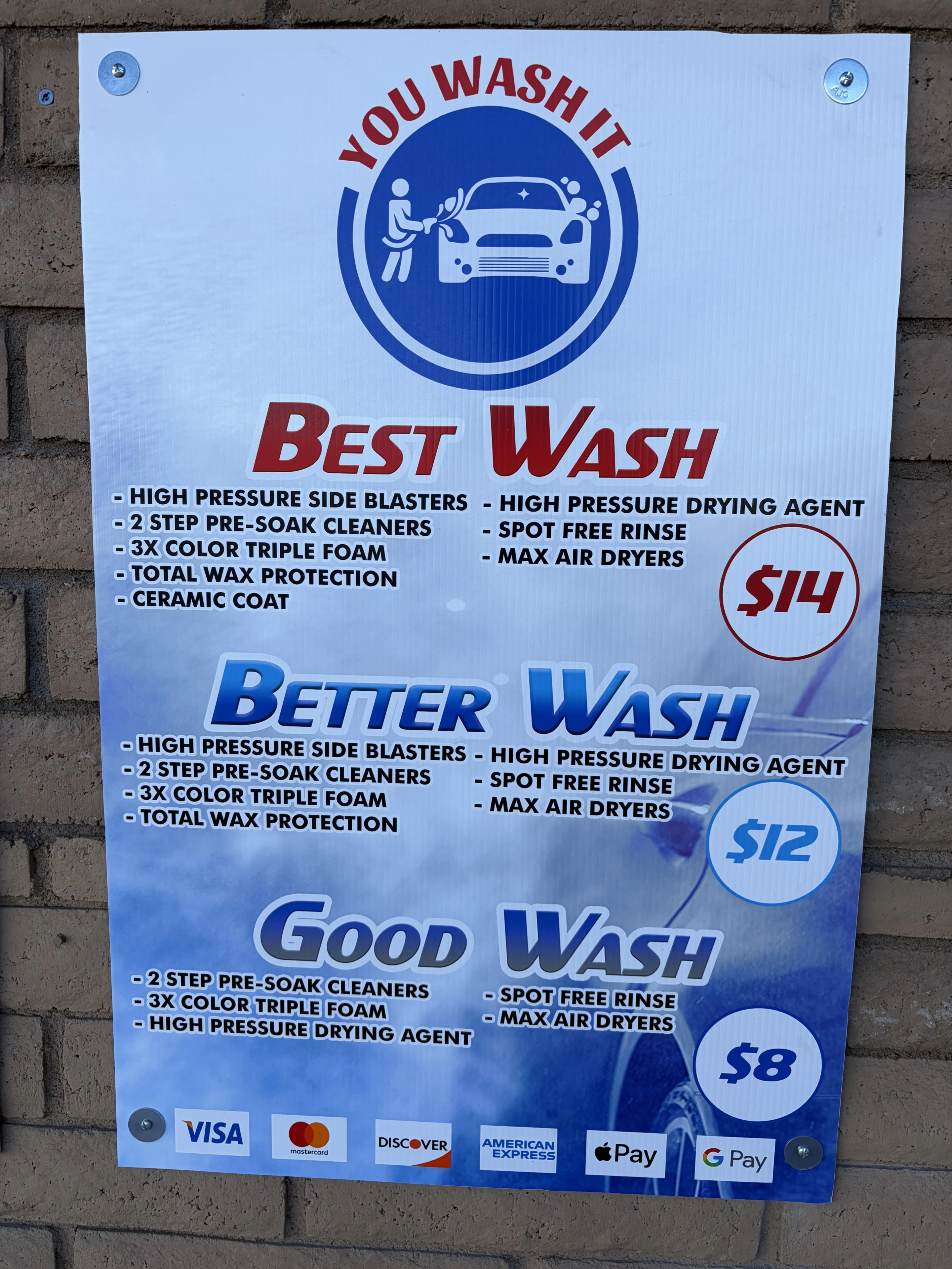 Car wash service pricing sign on wall.