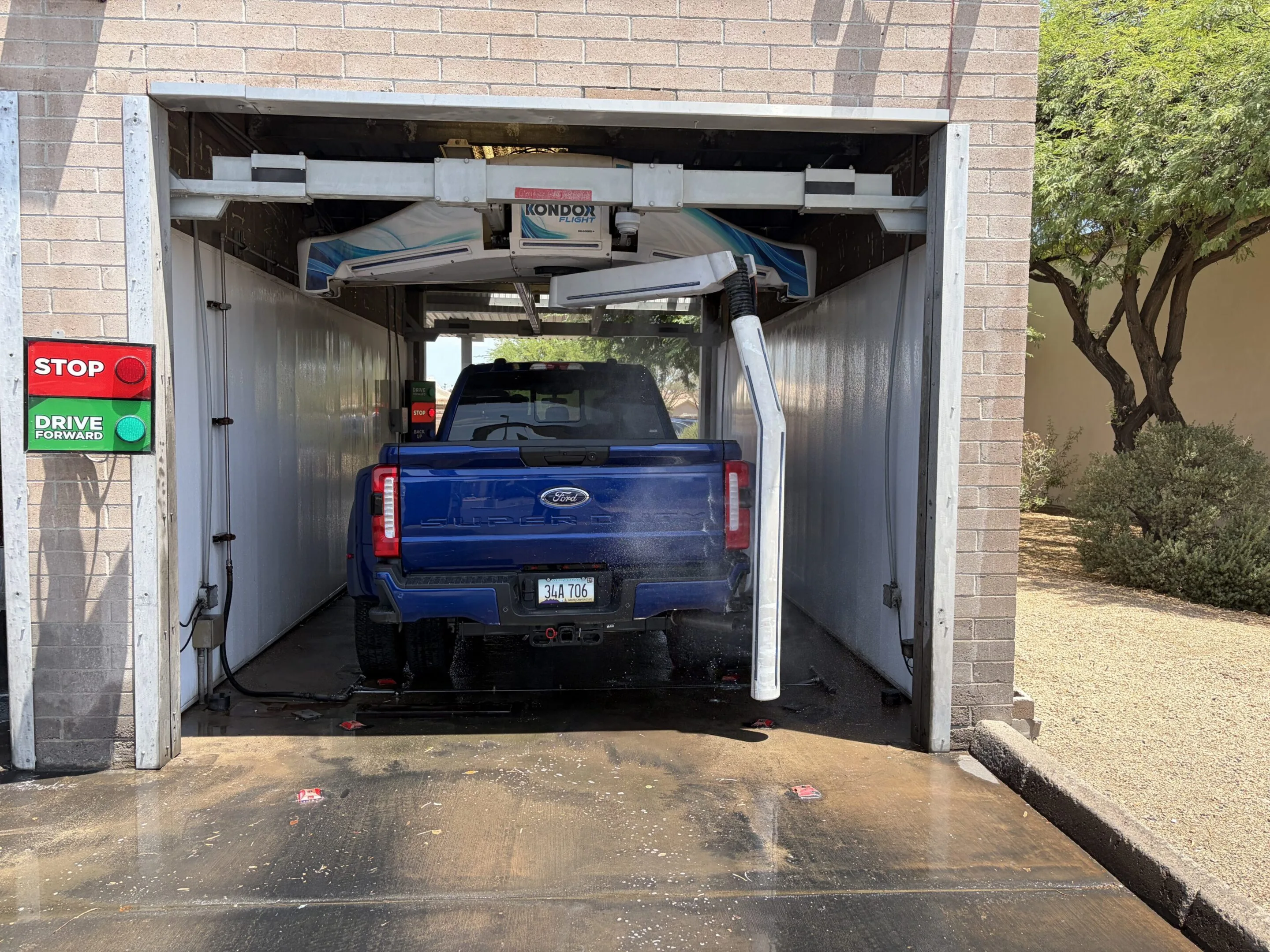 Blue truck parked in a garage with a sign on the wall