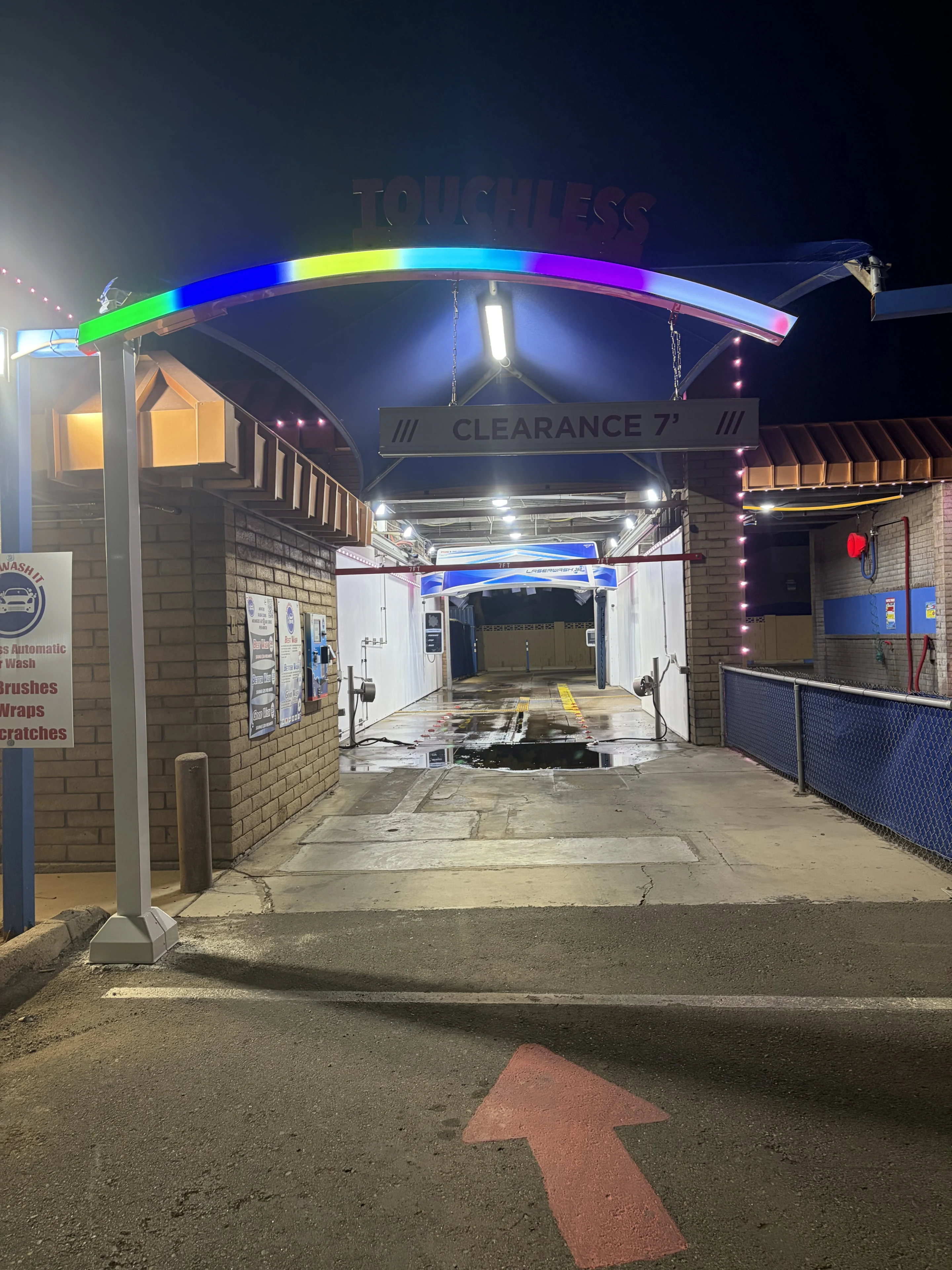 Touchless car wash entrance at night.